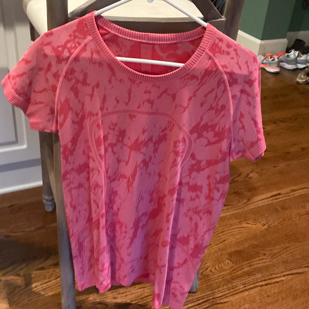 Pink Lululemon workout shirt.